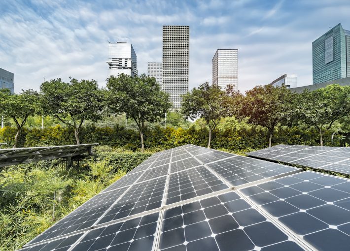 Ecological energy renewable solar panel plant with urban landscape landmarks