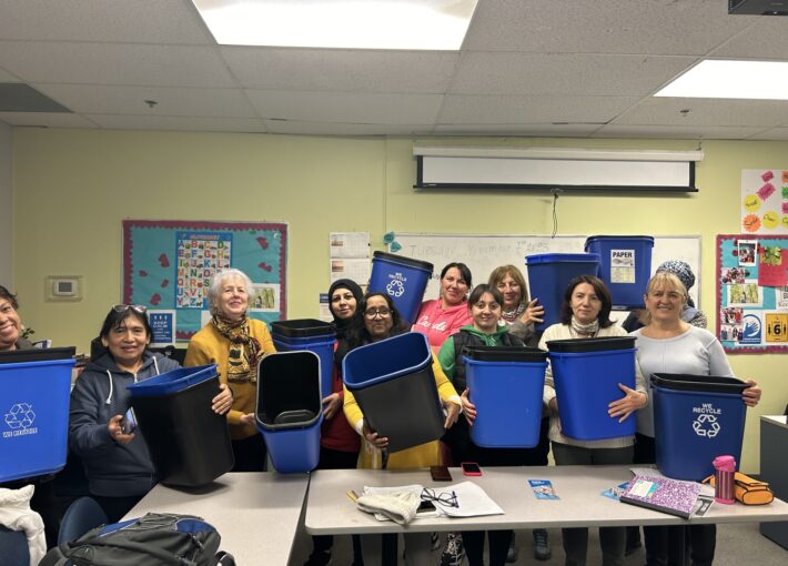 Group of women holding the waste bins they received from Newcomer Centre of Peel.